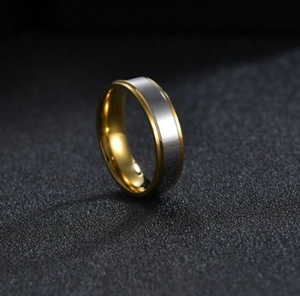 Macro detail of bicolor tungsten ring featuring brushed silver and gold plating