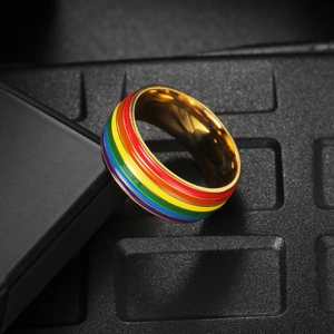 Titanium steel rainbow pride ring with colorful enamel stripes and polished gold edges