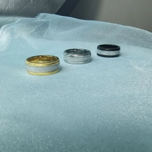Macro shot of industrial titanium steel rings with meteorite texture and gear edges