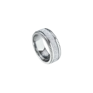 Macro detail of men's titanium steel ring with meteorite texture and grooved edges