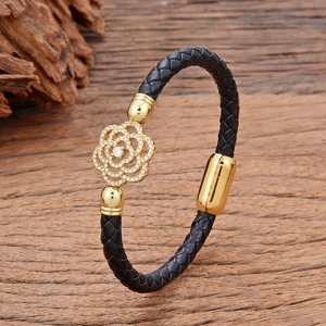 Braided black leather bracelet with gold camellia flower charm and magnetic clasp
