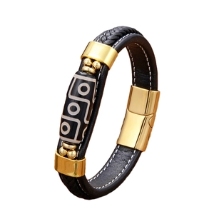 Men's ethnic braided leather bracelet featuring Dzi bead and golden metal clasp