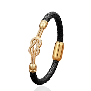 Handwoven black leather bracelet with a gold-plated knot charm and sparkling cubic zirconia