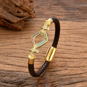 Braided black leather bracelet with gold metal diamond-shaped centerpiece and colored rhinestones