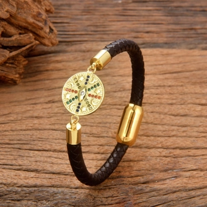 Braided black leather bracelet with golden starburst charm and colorful gemstones