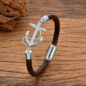 Men's brown braided leather bracelet featuring a silver anchor pendant with crystals