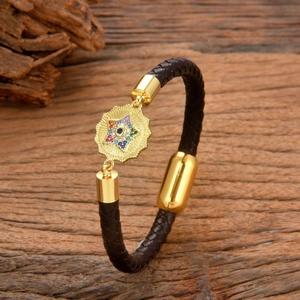 Braided brown leather bracelet with golden magnetic clasp and colorful crystal star charm