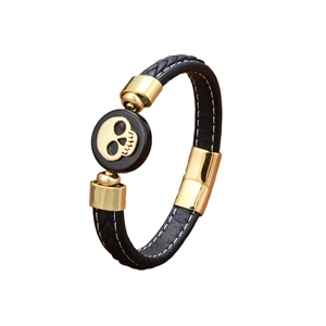 Punk woven leather bracelet for men featuring a gold skull charm and magnetic clasp