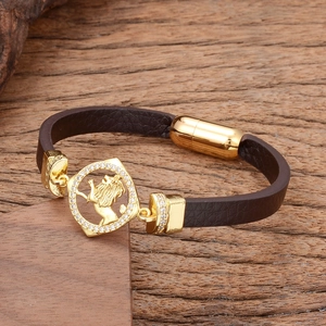 Men's dark brown leather bracelet featuring a gold lion head charm with white crystals