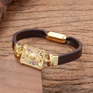 Brown leather bracelet with gold plaque featuring multi-color stones and magnetic clasp