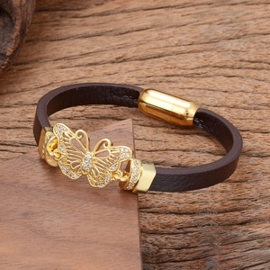 Detailed close-up of dark brown leather bracelet with golden butterfly zircon centerpiece