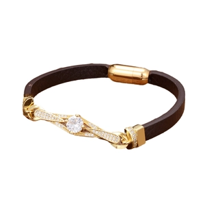Ethnic brown braided leather bracelet with a gold diamond-encrusted geometric centerpiece