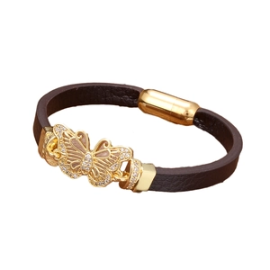 Deep brown leather bracelet with golden butterfly charm and magnetic clasp on white background