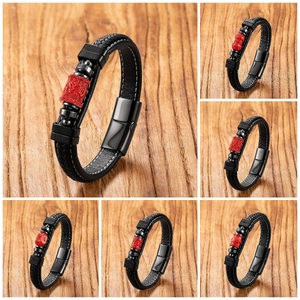 Detailed views of braided leather bracelets with red cinnabar lotus beads and metal clasps