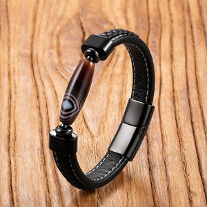 Men's leather bracelet with agate stone bead and magnetic clasp on wooden background