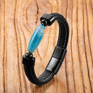 Men's braided leather bracelet with blue agate stone on a natural wood background