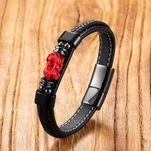 Ethnic black braided leather bracelet featuring a red cinnabar buddha and metal clasp