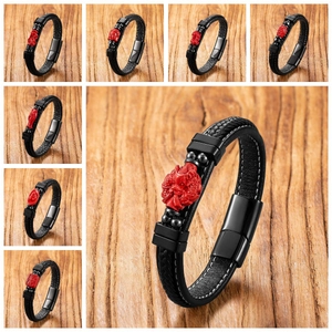 Close-up of leather bracelet with red cinnabar buddha head and magnetic steel clasp
