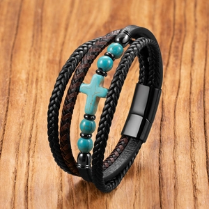 Macro detail of multi-layer leather braid with turquoise cross and magnetic clasp