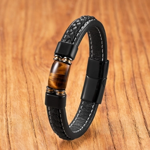 Mens woven leather bracelet with tiger eye stone and black magnetic clasp on wood