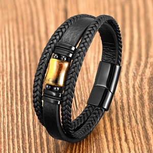 Black leather multi-layer bracelet with tiger eye stone and magnetic clasp on wood