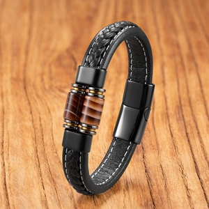 Dettaglio di perle occhio di tigre e bracciale in pelle intrecciata nera con chiusura magnetica