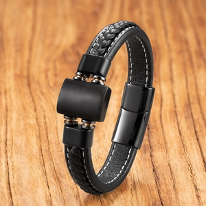 Detail of black woven leather men's bracelet with contrast stitching and metal clasp