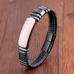 Detail of black leather bracelet with pink stone inlay and magnetic metal clasp