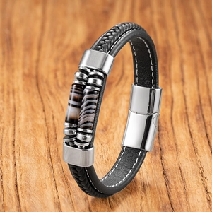 Detail of woven black leather bracelet with striped stone beads and silver magnetic clasp
