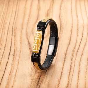 Close-up of ethnic braided leather bracelet with mystic eye bead and magnetic clasp