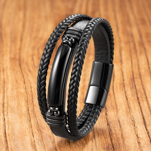 Détail d'un bracelet multicouche en cuir noir avec œil de tigre et fermoir magnétique