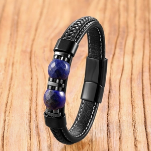 Detail view of woven black leather bracelet with tiger eye beads and magnetic clasp