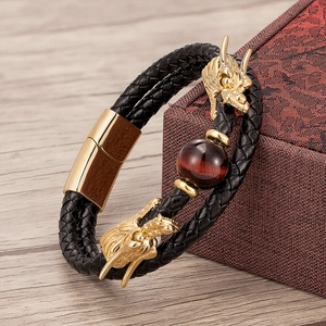 Close-up of double-braid leather bracelet with golden dragon head and red tiger eye stone