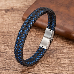 Macro shot of black and blue braided leather men's bracelet with silver stainless steel clasp