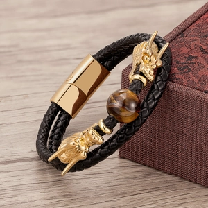 Detail of dragon head leather bracelet with tiger eye stone and gold magnetic clasp