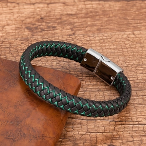 Detail of woven black leather bracelet with green stitching and silver magnetic clasp