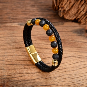 Detail of men's leather cord bracelet with volcanic stones and golden magnetic clasp