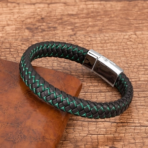 Close-up of black braided leather bracelet with green stitching and silver magnetic clasp