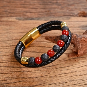 Detail of men's leather cord bracelet with red beads and golden magnetic buckle