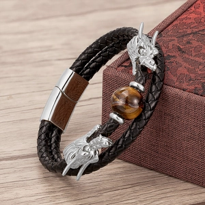 Detail of dragon head leather bracelet with tiger eye stone on jewelry box