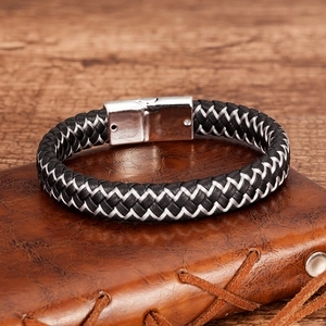 Detail of black and white braided leather bracelet with silver magnetic metal clasp