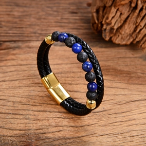 Detail view of woven black leather rope bracelet with gold clasp and natural stone beads