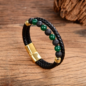 Detail view of men's double-layer leather and green agate stone bracelet on wood