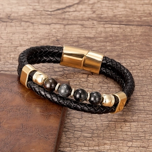 Gros plan du bracelet pour homme en cuir tressé noir avec fermoir magnétique doré