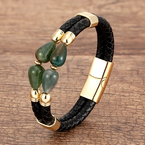 Detail of woven leather bracelet with gold magnetic clasp and green teardrop stones