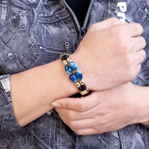 Men's double-layered leather bracelet with blue agate beads and gold clasp on wrist