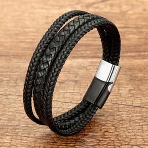 Macro detail of multi-strand black braided leather bracelet with magnetic metal clasp