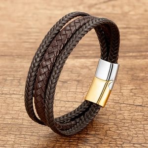 Detail of multi-layer braided leather bracelet with two-tone magnetic metal clasp
