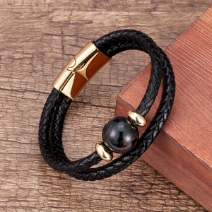 Detail of double-layer woven leather bracelet with tiger eye stone and gold magnetic clasp