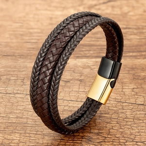Close-up of dark brown multi-layer braided leather bracelet with gold magnetic metal clasp